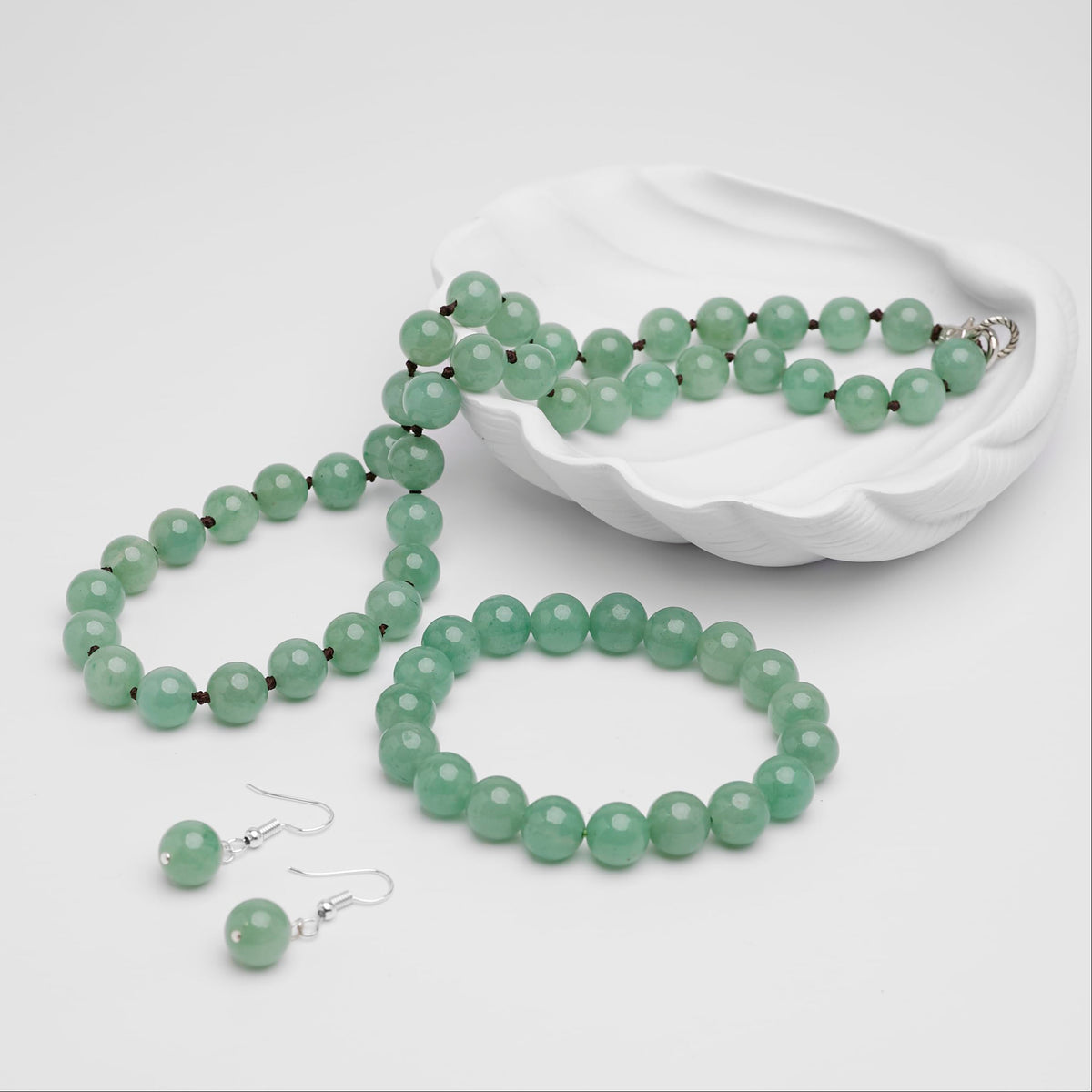 Women’s green aventurine jewellery set with a hand-knotted 10mm faceted bead necklace, matching stretch bracelet and silver-tone hook earrings.