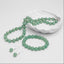 Women’s green aventurine jewellery set with a hand-knotted 10mm faceted bead necklace, matching stretch bracelet and silver-tone hook earrings.