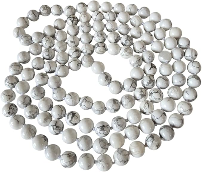 Long white bead necklace with polished 8mm round beads and contrasting grey veining, arranged in overlapping loops.